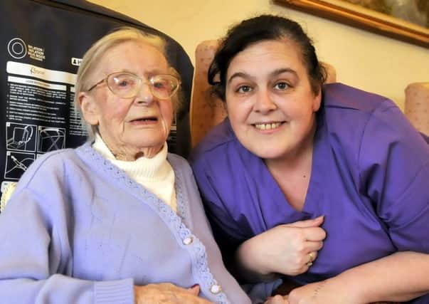 Christabel Atkinson, 100 years old on 17th December 2018. She lives in Greenroyd Care Home, Hest Bank. She is pictured with Senior Carer Deniece Smith