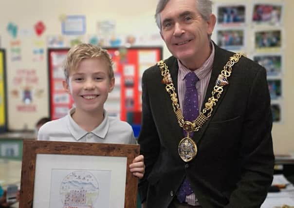 Will Lakin, 10, with Mayor of Lancaster Andrew Kay and the winning card design.