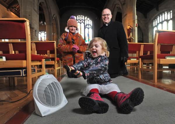 St Barnabas Church are crowdfunding to help fix the heating in the church. Pictured is Father Michael Childs with 2-year-old daughter Lucy and church warden Morna Murgatroyd.