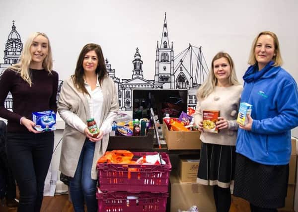 It's Ellys Bagnall, Fiona Lambert, Becky Sewell and Joanna Young, from Hotfoot Design, with their donation for Morecambe Bay Foodbank.