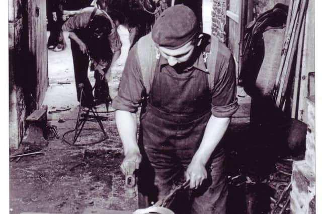 Bryan Taylor making a horseshoe and brother Frank trimming the hoof. Holding the horse is farmer Matt Robinson. Photography by Bertram Unne of Slaidburn Smithy around 1948-49.