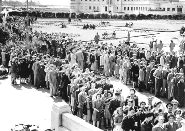 Queues of people waiting outside the super swimming stadium in Morecambe in 1945.