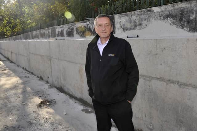 Steve Thomas with the new flood defences at Standfast and Barracks