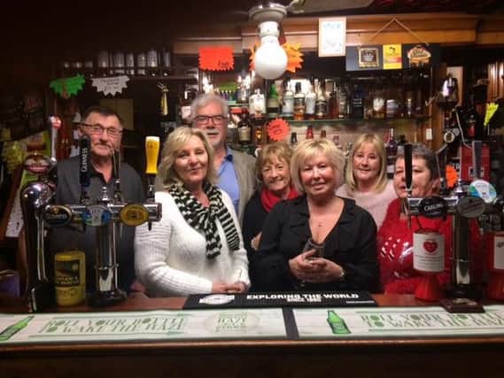 Cath Hadwin (second from the left) and Lynda Steward, with, left to right,  Woodies landlord Dave Carter and friends Norman Pickvance, Sue Brown, Helen Coxhill and  landlady Jane Carter