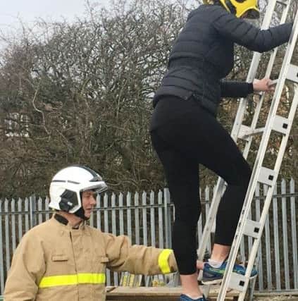 Firefighters help visitors to 'Have a Go' at their taster day.