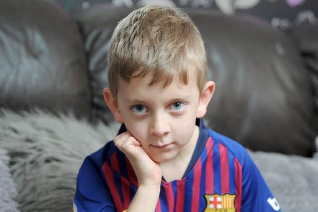 Seven-year-old Zac Harrison fractured his skull after a metal goal post fell on him.