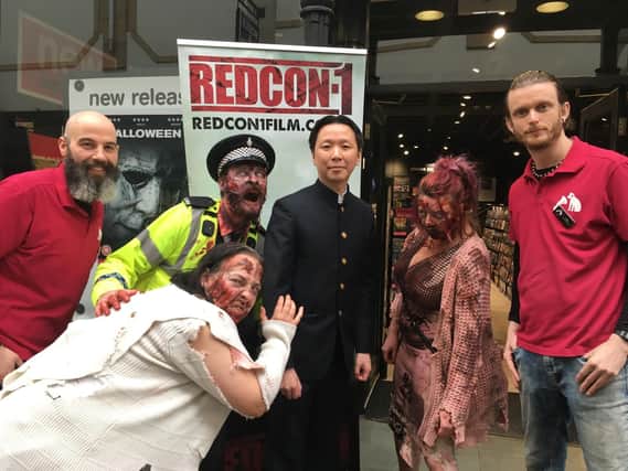 From left: HMV store manager Matt Beddows, Chee Keong Cheung, HMV's assistant manager Liam Carroll with the zombies