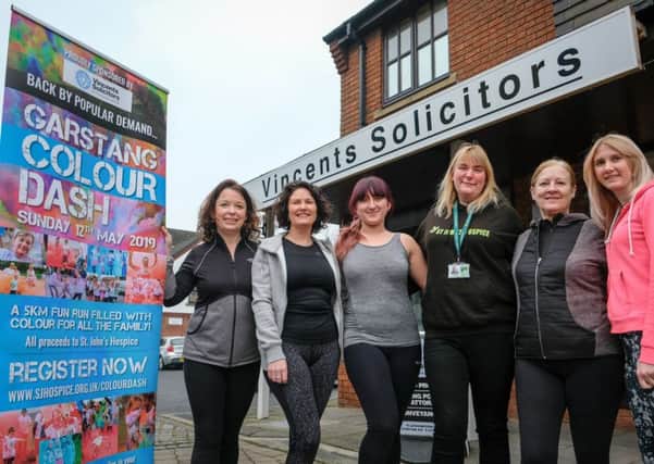 The Vincents Solicitors team prepares for the Garstang Colour Dash, with Zosia Muhler from St Johns Hospice.