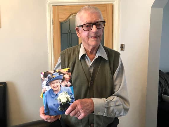 Jack Russell with a card sent from the Queen to mark his 75th wedding anniversary to wife June in February.