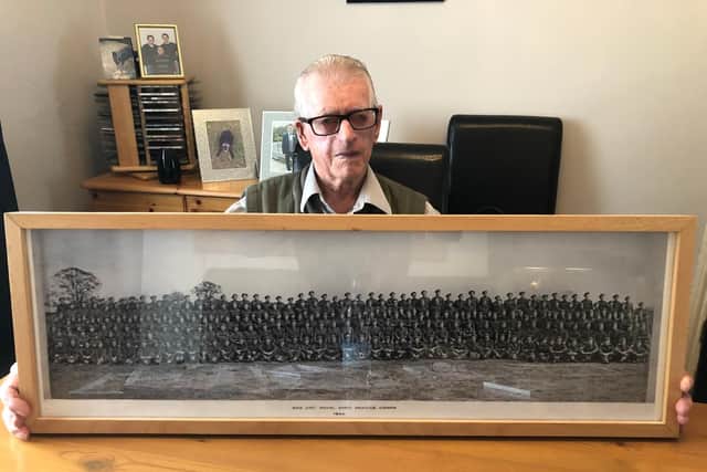 Jack Russell with a picture of his comrades from the D-Day Landings during the Second World War.