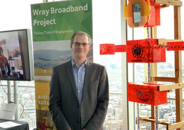 Prof Nick Race alongside the digital scarecrow at the BT Tower in London