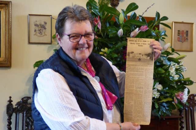 Head guide at Leighton Hall Pam Shred with the cutting from the Morecambe Visitor.