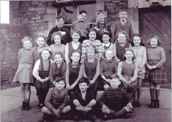 Wray School pupils, junior class, circa 1948. Back row from left: Joseph Woodhouse (Scale Farm, Roeburndale East), George Preece (Thornbush Farm, Roeburndale West), Alan Cornthwaite (No 1, Moor Cottage, Wray), Frank Harrison (Birks Farm, Botton.) Third row from left: Hazel Pritchard (The Cross, Wray), Ruby Atkinson (Crag Hall, Botton), Nora Cornthwaite (No 1, Moor Cottage, Wray), Margaret Mashiter (Harterbeck Farm, Roeburndale East), Margaret Huddleston (Procter's Farm, Wray), Joyce Kenyon (No 1, Holme View, Wray), Margaret Kenyon (Moor House, near Wray), Jean Whittam (Bridge End, Wray), Jean Fox (George and Dragon Public House, Wray). Second row from left: Lucy Gorst (Bellhurst Farm, Roeburndale East), Winnie Stephenson (Above Beck Farm, near Wray), Brenda Ralston (Roeburn Terrace, Wray), Edith Gorst (Bellhurst Farm, Roeburndale East), Margaret Wilson (Bridge End, Wray), Jill Kenyon (No 1, Holme View, Wray). Front row from left: David Ralston (Roeburn Terrace, Wray), Ted Holmes (Barkingate Farm, Roeburndale