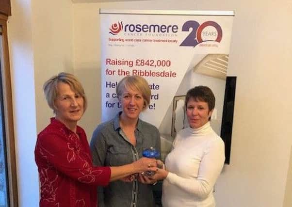 Silver linings for Jackie (left) and Liz as they receive their award for Rosemere Cancer Foundations Chief Office Sue Thompson (right).