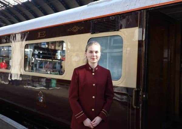 A stewardess stands alongside the Northern Belle.