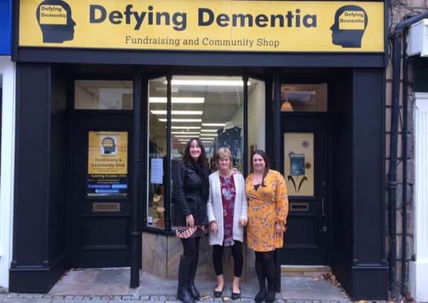Linda Warrington, Dr Penny Foulds and Linda's daughter Lucy at the Defying Dementia shop in Lancaster.