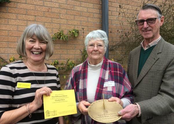 Bronwen and Peter Osborne receive their sundial from Lancashire County Organiser Margaret Fletcher (left).