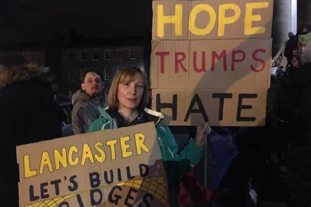Colette Bain, from Warton, with her signs at a previous anti-Trump protest in Lancaster.
