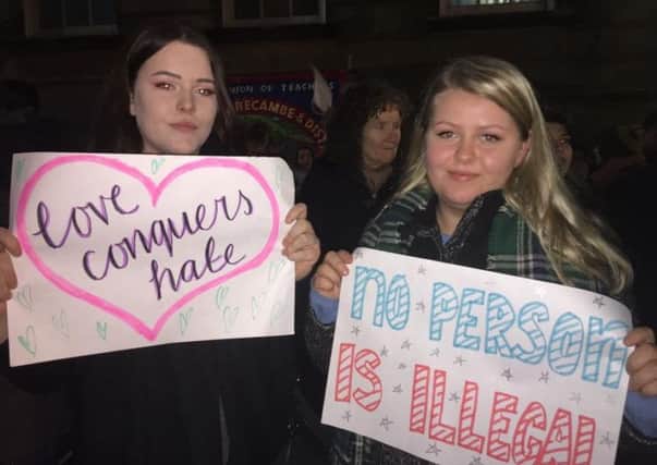 Morgan Hanley and Victoria Skorgevik with their signs at a previous anti-Trump protest in Lancaster.