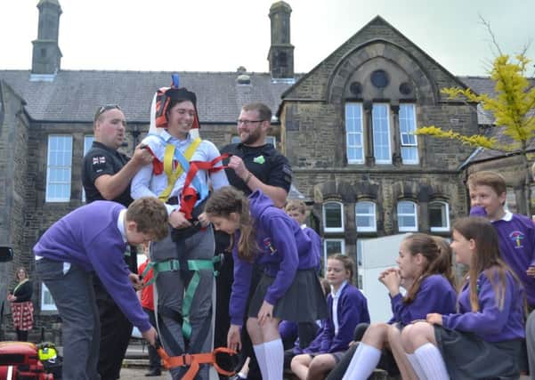 Pupils from Arkholme School watch as a student teacher is tied to a stretcher during rescue demonstration carried out by Lancaster Area Search and Rescue officer in charge (back left) Alex Bowden and probationer Dan Rawes (back right) at the flood awareness day held at the University of Cumbria campus in Bowerham Road, Lancaster on Thursday 6 June 2019