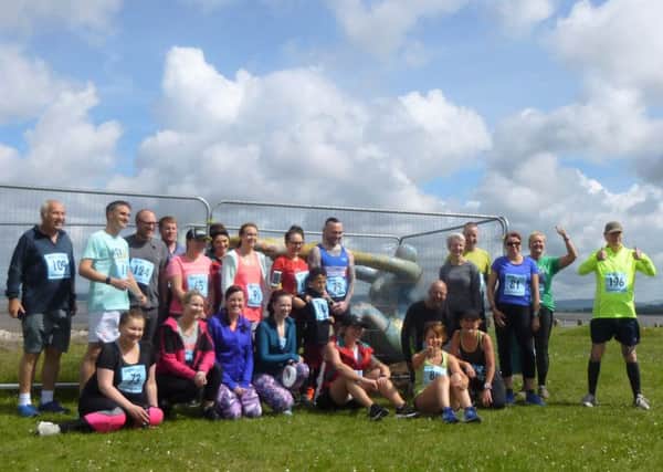 Venus and Cupid surrounded by people that took part in the 5k fun run to raise money for the statue repairs. Picture: Dawn Latham.