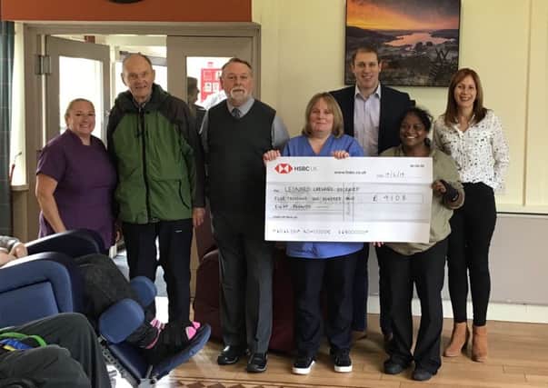 Diane and Nick Armstrong with Holehird staff and residents at the cheque presentation.
