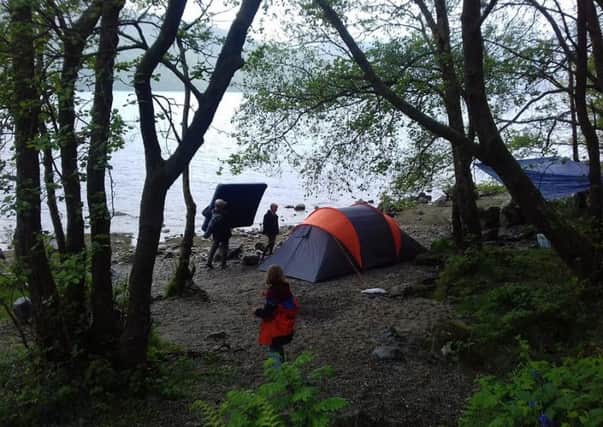 Building the camp on the beach at Loch Lomond