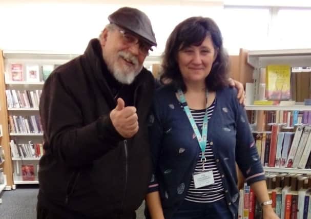 Poet Bryan Griffin with an assistant at Heysham library which is hosting poetry and acoustic open mic nights starting in July.