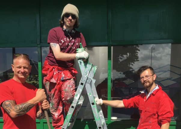Firefighter Michael Parker, Kailen Phillips and Giles Sowerby work on the former bus waiting room on Central Drive, Morecambe, which has been turned into a hangout shelter for young people in the town.