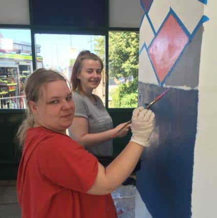 Katelyn Plows (left) and Kezni Smith work on the former bus waiting room on Central Drive, Morecambe, which has been turned into a hangout shelter for young people in the town
