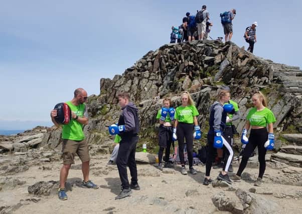 The Central Lancaster High School pupils take part in a boxing session at the summit of Snowdon.