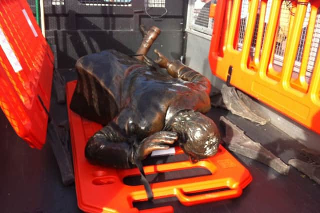 The damaged Eric Morecambe statue lies in the back of a council van.