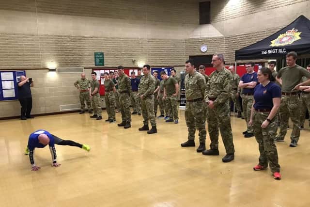 Reserve soldiers from Lancaster take part in the charity Cha Cha Slide Plank with personal trainer Steve Cody who is doing the exercise every day throughout 2019 with different groups to raise money for CancerCare.