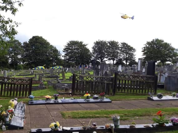The Air Ambulance taking off from Hale Carr Cemetery.