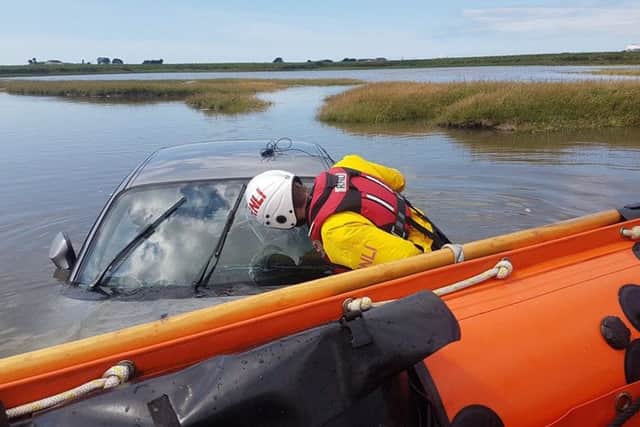 Two motorists were rescued after their vehicles were submerged near Sunderland Point.