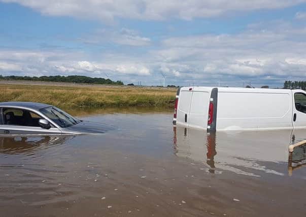 Two motorists were rescued after their vehicles were submerged near Sunderland Point.