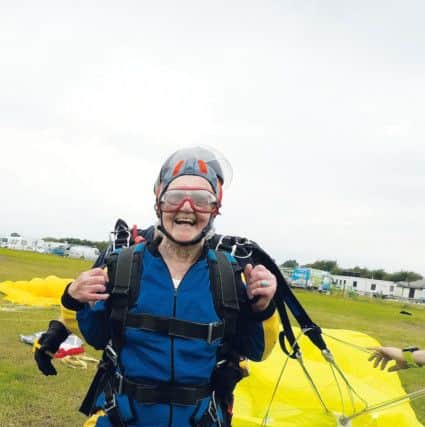 Adeline safely on the ground after her skydive.