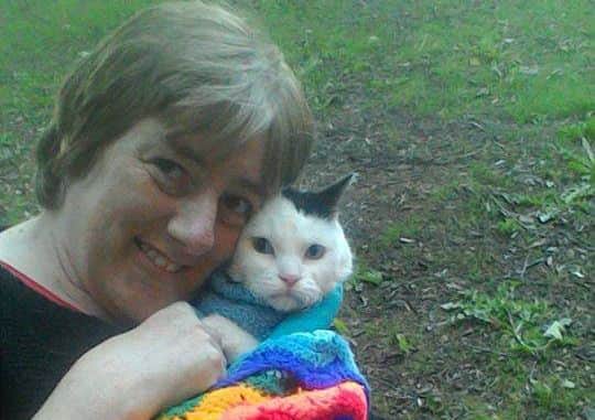 Julie with Toby and one of his knitted blankets.