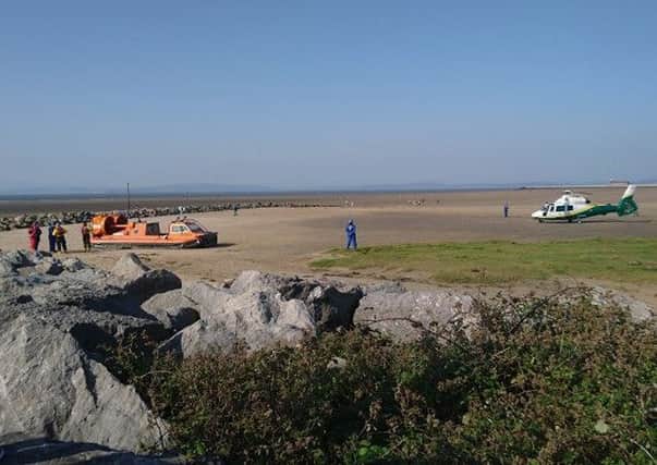 The lifeboat and air ambulance land on the beach on Sunday to help with the rescue. Photo by David Goulding.