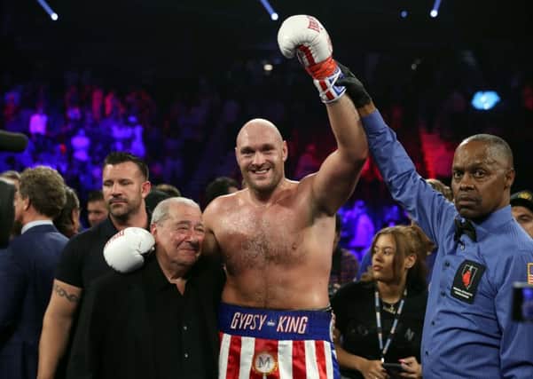 Tyson Fury poses with boxing promoter Bob Arum and referee Kenny Bayless after defeating Tom Schwarz during a heavyweight fight at MGM Grand Garden Arena on June 15, 2019 in Las Vegas, Nevada. Fury won with a second-round TKO.  (Photo by Steve Marcus/Getty Images)