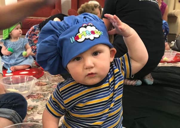 One of the babies in a chef's hat.
