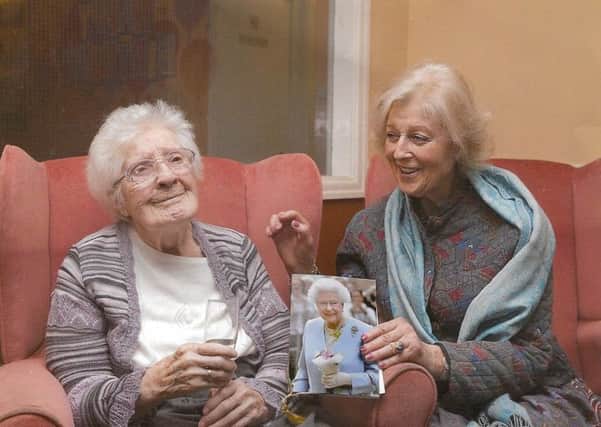 Marjorie Dawson celebrating her 100th birthday with Princess Alexandra, who is holding a card from the Queen.