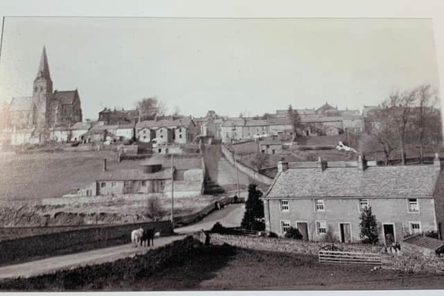 Burton-in-Lonsdale circa 1908. To the left of Burton Bridge stands Greta Bank pottery, owned by William Bateson. It was one of the last surviving potteries in the village. The photograph shows the top of the kiln, surrounded by a hovel, this protected the workers whiilst they shovelled coal into the fire mouths or unpacked the fired pottery. On the hill stands the church of All Saints with its lofty octagonal spire, a visible landmark for miles around.