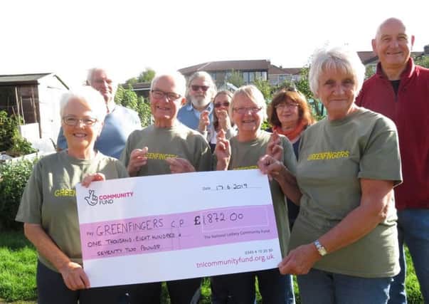 Daisy Bank allotment users celebrating after receiving a cheque for £1872 from the National Lottery fund. The money was used to replace a compost toilet on the allotments.