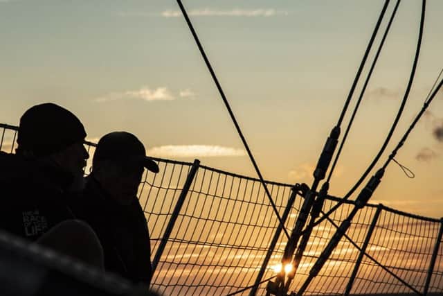 Some of the crew on the yacht at sunset. Credit: Clipper Race