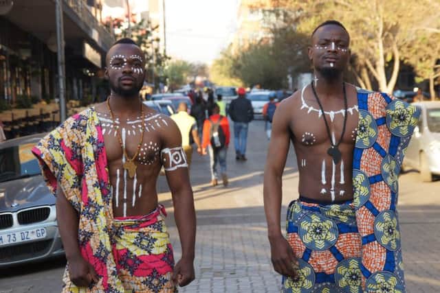 #comingtogether shows traditional Congolese dress and colours, worn by a South African and a Congolese on the streets of the Johannesburg. The photo highlights the importance of unity.