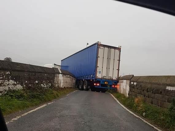 The lorry became trapped on a bridge near the A6 in Lancaster at 7.40am this morning (October 24)