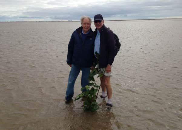 Cedric Robinson (left) with author Lindsay Sutton pictured in Morecambe Bay - literally!