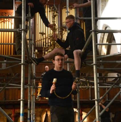 Lancaster Priory's historic candelabra being dismantled to make way for The Moon. Photo by Darren Andrews