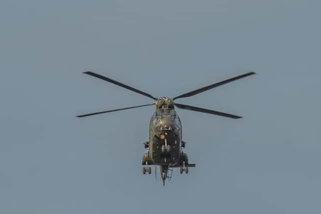 One of the helicopters hovers over the cricket pitch in Heysham. Photo by Janet Packham.